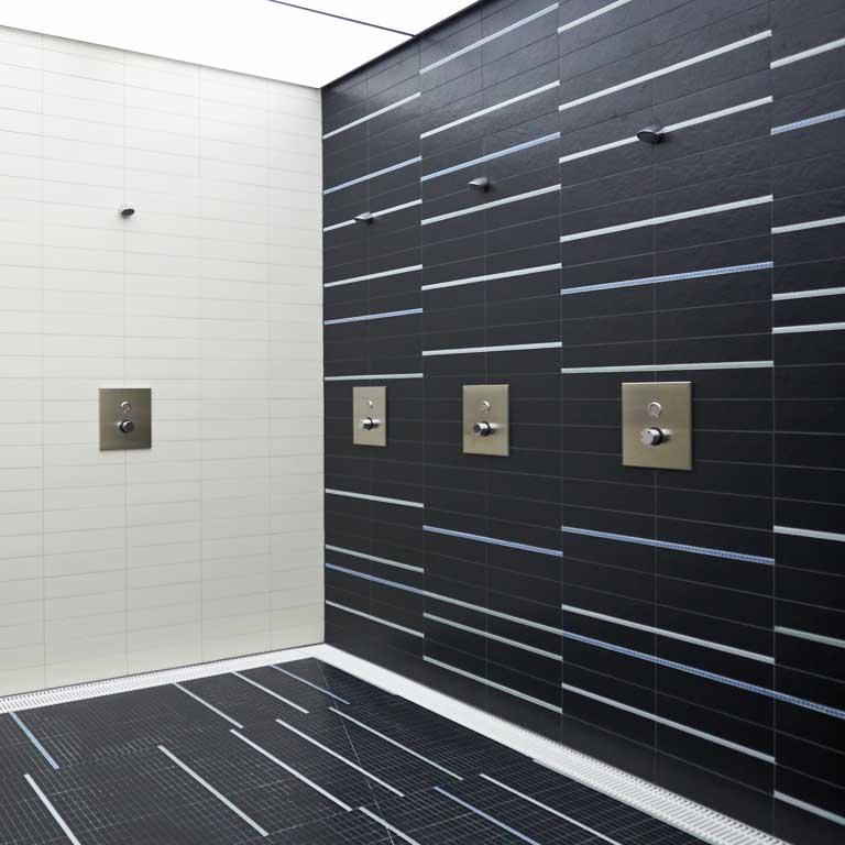 Das Schwarz-Weiß-Thema bestimmt das gesamte Gebäude und ist an der Fassade ebenso zu finden wie im Innern z.B. bei den Spinden und in den Duschen.