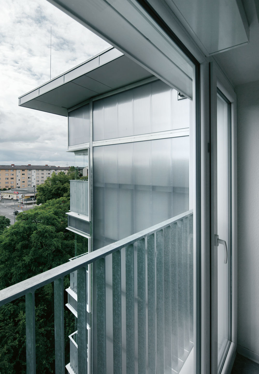 Blick aus dem Obergeschoss nach Westen. Die von Aluminiumprofilen gehaltene Fassadenverkleidung aus Polycarbonat ist zerstörungsfrei rückbaubar.