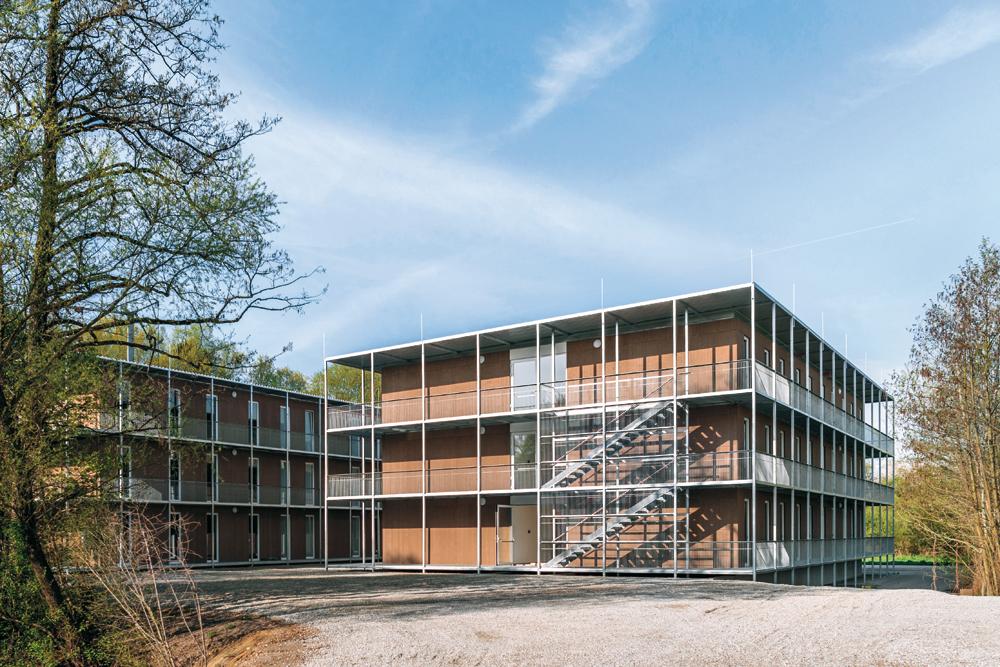 Holzmodule, temporäre Flüchtlingsunterkunft in Zolling, 2016, Architekten: seidlkern
fertiges Gebäude mit Umgang für konstruktiven Holzschutz als Fluchtweg und Aufenthaltsraum