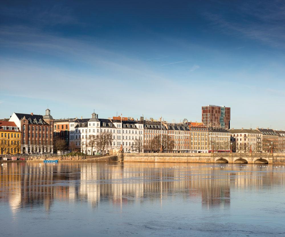Stadtpanorama von Süden; im Vordergrund der Sortedam-See. Der Neubau überragt die Nachbarhäuser im Stadtviertel Indre NØrrebro deutlich.