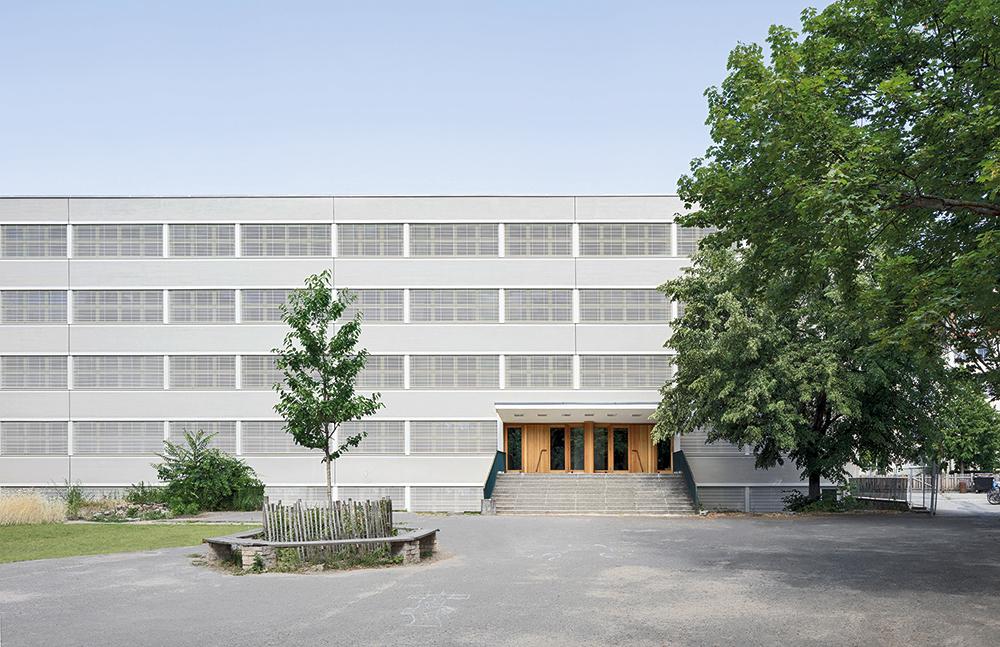 Der neue Kinderhort dockt hofseitig an den Plattenbau am Prenzlauer Berg an. Die wabenförmigen Module des Horts bilden vielfältig nutzbare Nischen im Außenraum aus.