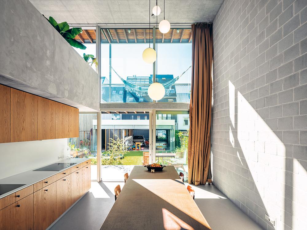 The house opens to the south with balconies and terraces on every level. A double-volume kitchen/dining area is the central meeting place in the lower dwelling unit.