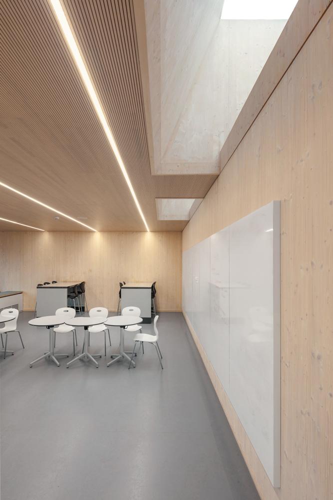 Im fast 10 m hohen Dachgeschoss des Anbaus befindet sich das Auditorium. Die Konstruktion aus Furnierschichtholz ist sichtbar geblieben.