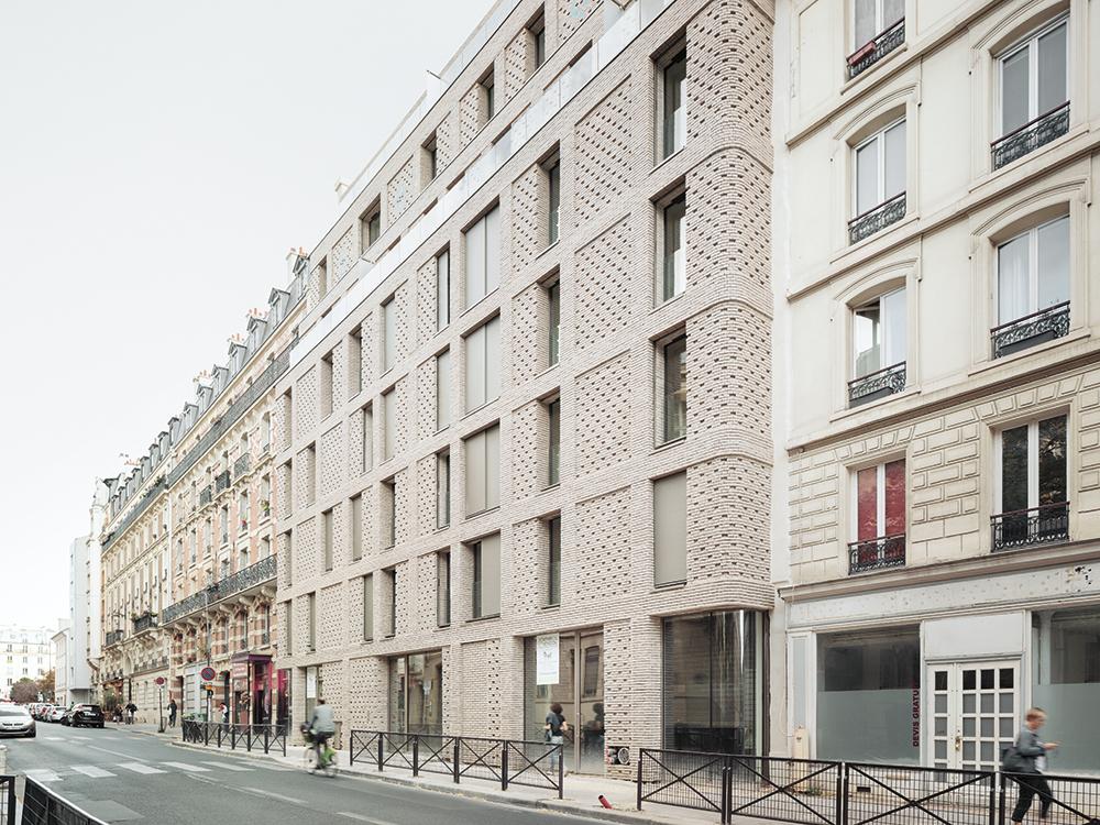 The Rue Charenton is one of the longest and oldest streets in Paris. This new struc- ture, with its pale brick facings, fits in well between the adjoining buildings.