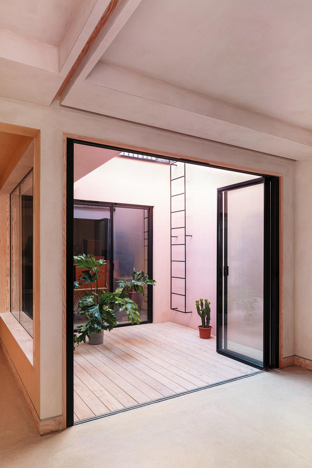 Two patios and a skylight above the open staircase structure direct daylight into the lower level.