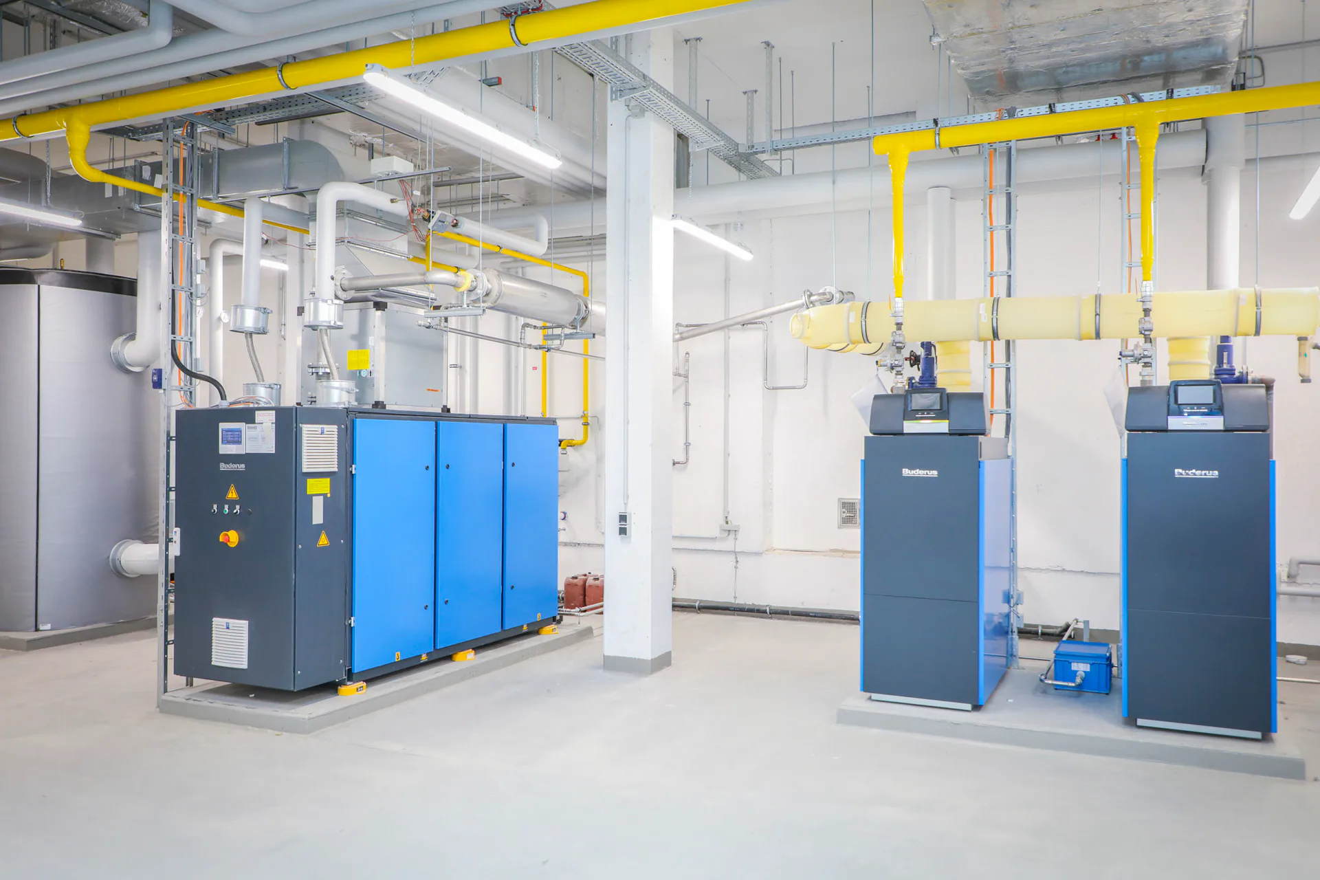 Im Heizraum sind ein Blockheizkraftwerk Loganova EN50 (links) und zwei Gas-Brennwertkessel Logano plus KB372 im System vereint.