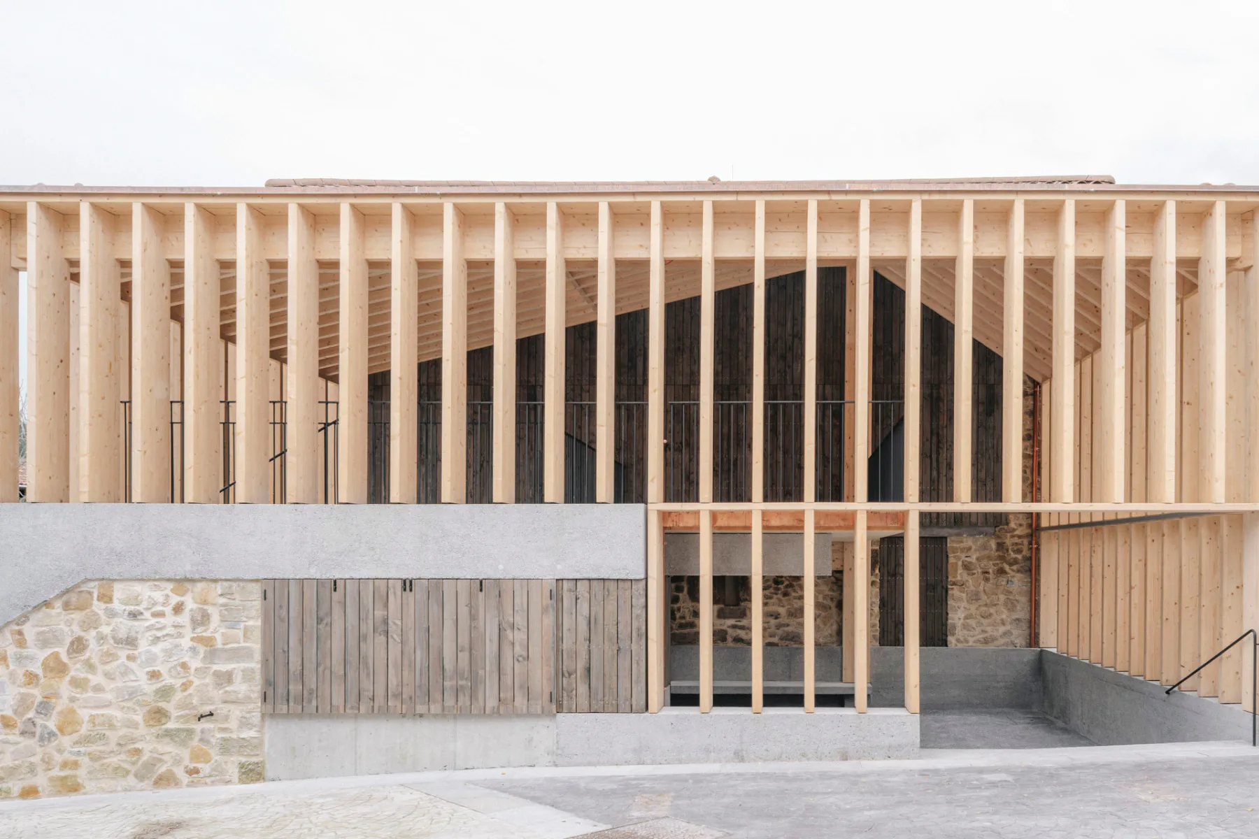 In der Südfassade lässt sich die Komplexität der Konstruktion aus Holz, Beton und altem Mauerwerk erahnen.