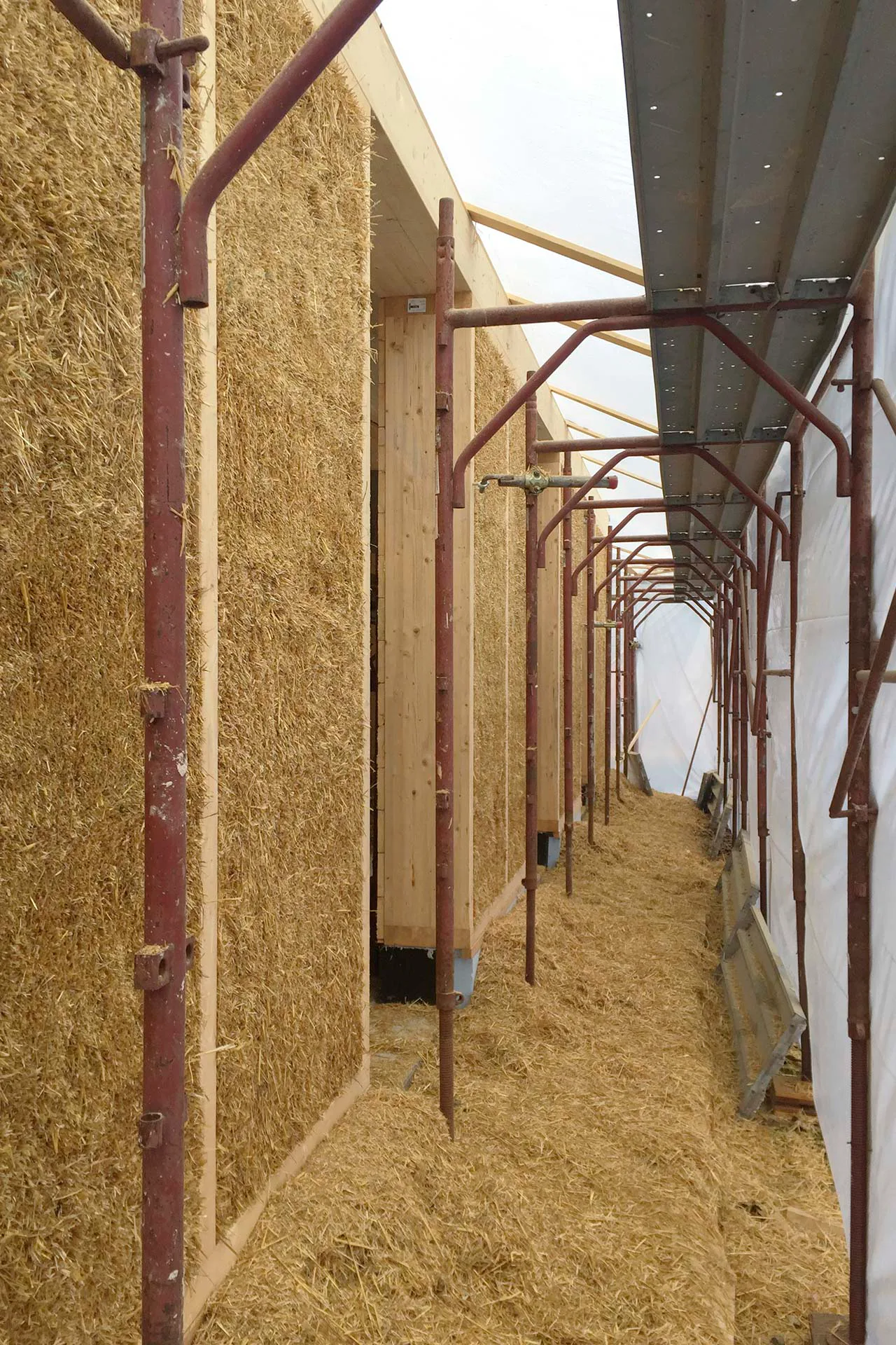 Holz und Stroh sind die beiden wesentlichen Baumaterialien für Fassaden und Dach.
