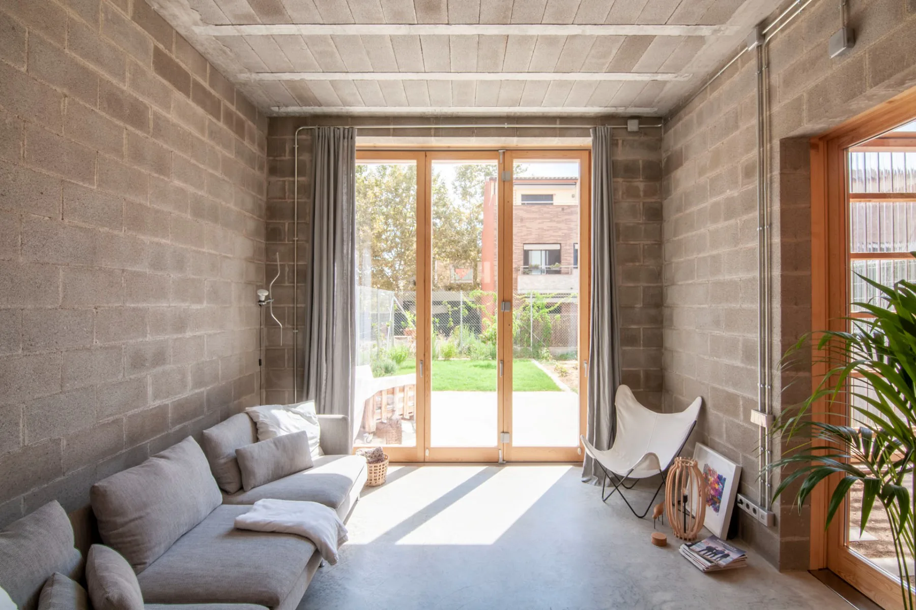 Naked concrete in various forms creates the floors, walls and ceilings of the living spaces of Casa 0006 near Barcelona.