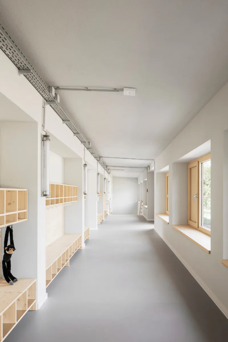 Möbel und Fenster aus Fichtenholz bilden eine visuelle Einheit.
