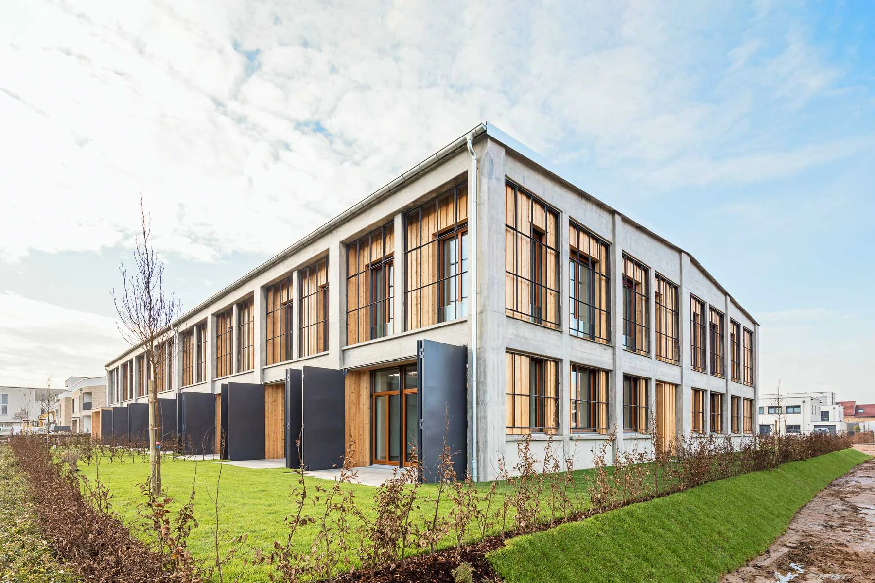 Das industrielle Erscheinungsbild blieb im Zuge der Umnutzung erhalten. Die Öffnungen des Bestandes geben den Blick auf das eingestellte Gebäude frei.