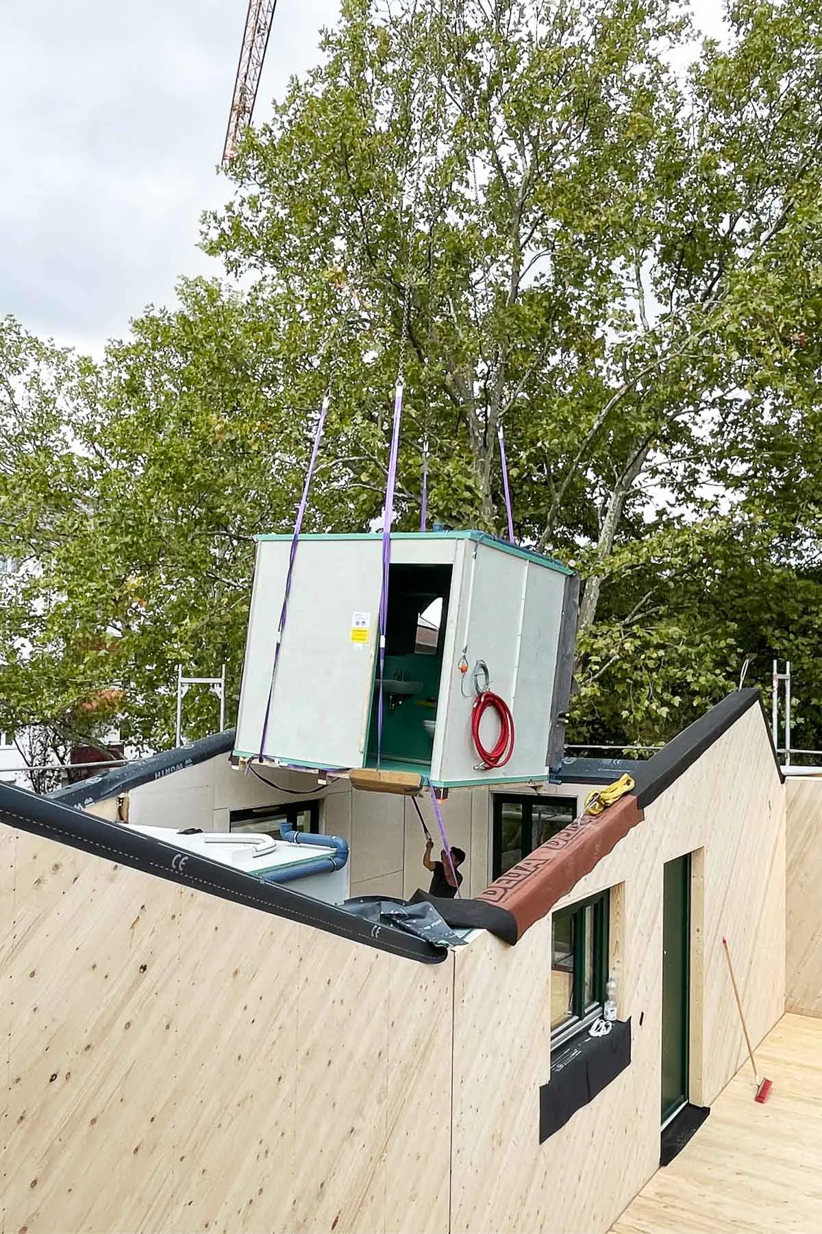 Prefabricated bathrooms simplify construction.