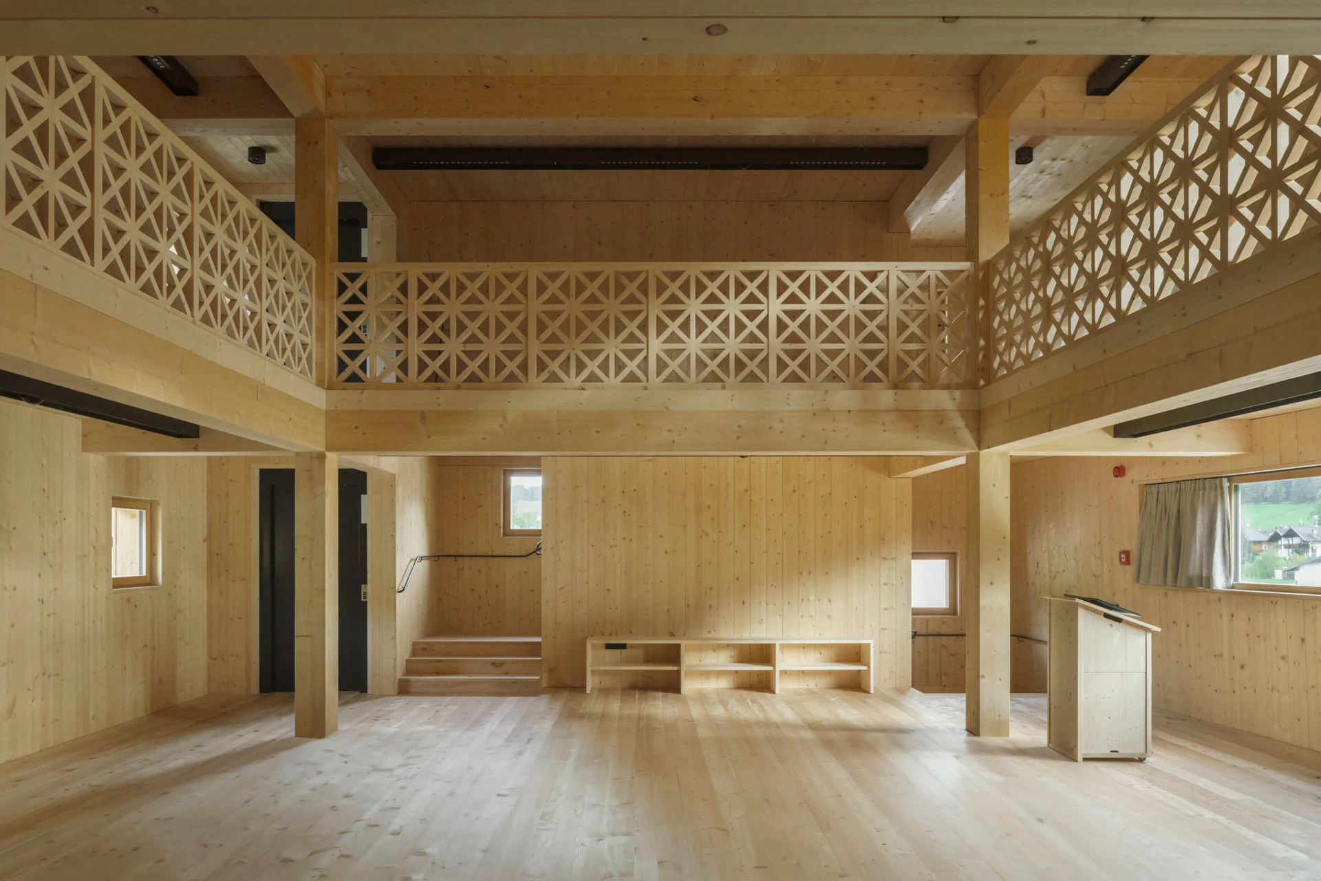 View of the double-height exhibition and event space with surrounding gallery.