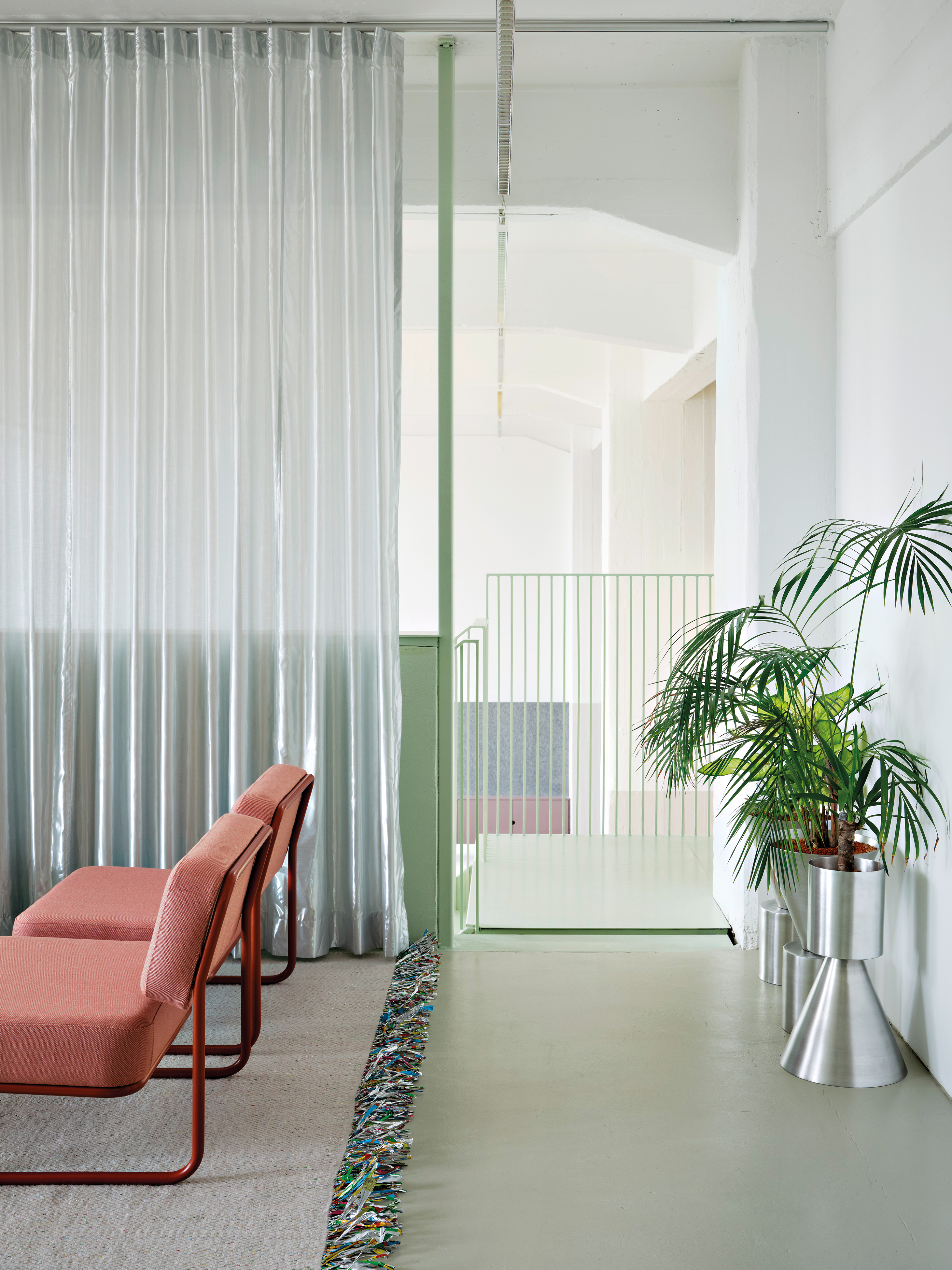 Die Lounge ist mit kobaltblau eingefärbten MDF-Platten gestaltet. Hinter einer Rückwand verbirgt sich eine Treppe, die auf die Galerie führt. Sitzstufen und Regalflächen verwandeln den Bereich in eine Lese- und Ausstellungszone.