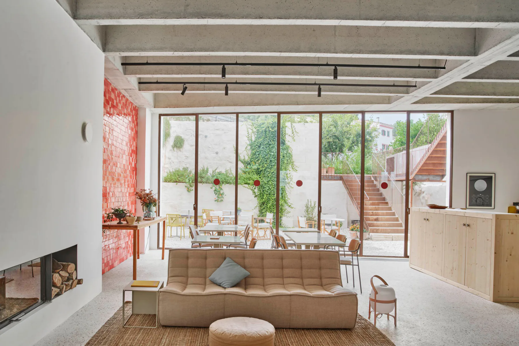 Exposed concrete ceilings and micro-cement floors characterise the interior.