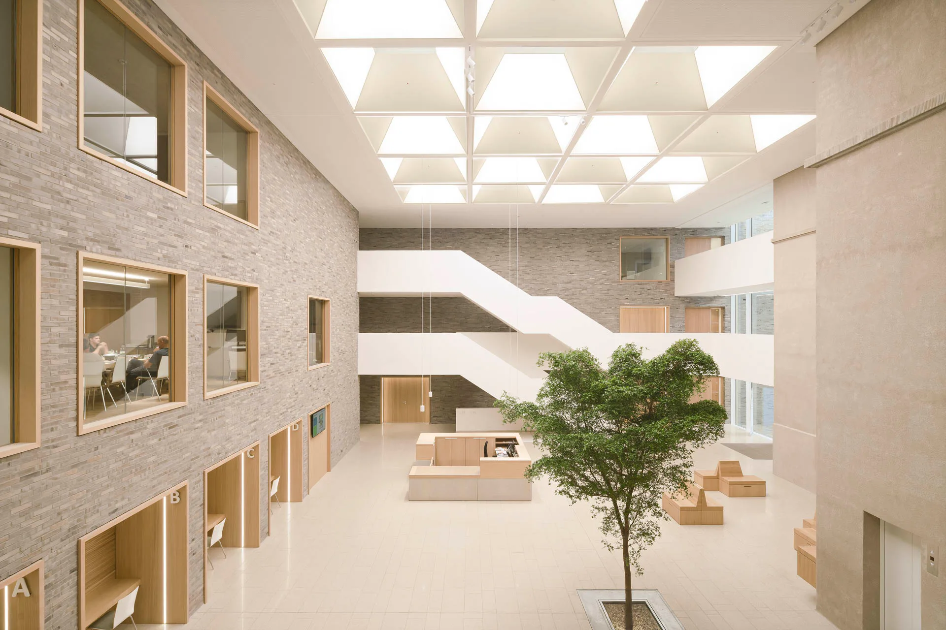 Das Zentrum der Anlage bildet die neu geschaffene Halle, die von oben durch großzügige Oberlichter erhellt wird.