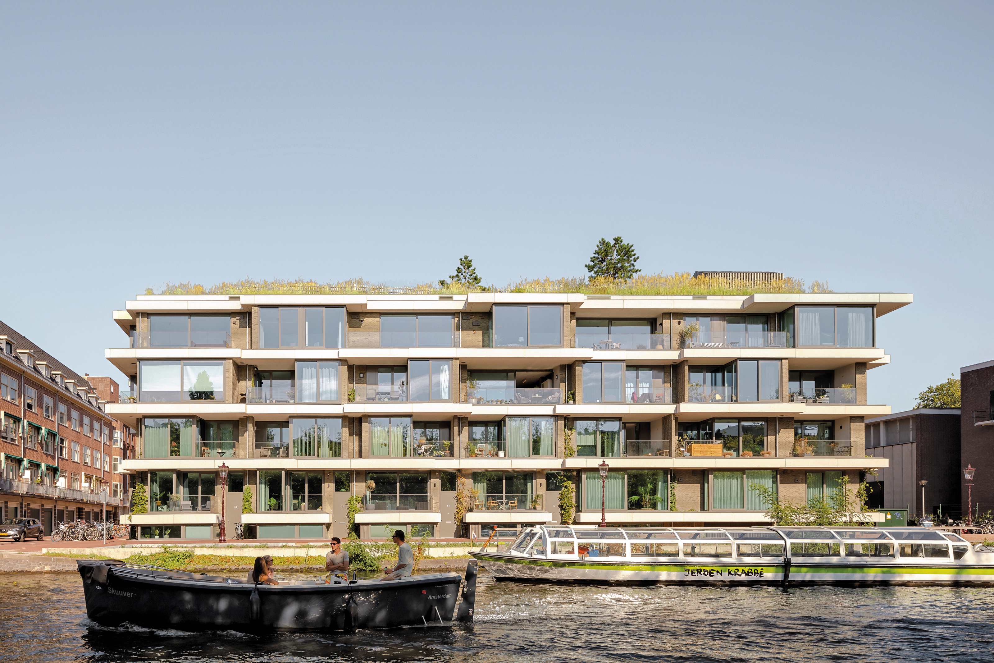 Visitors to the 11-storey Sluishuis can paddle by boat or stand-up paddleboard through the public courtyard basin beneath its striking 52 metre cantilever.