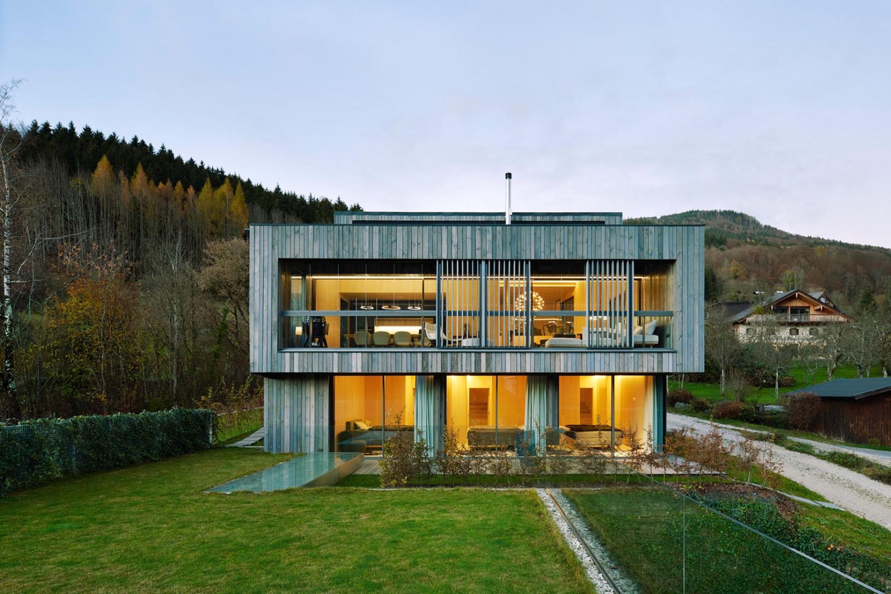 Die Südfassade öffnet sich mit großen cero Schiebefenstern Richtung See. Im EG schützt ein Dachüberstand vor sommerlicher Überhitzung, im OG ist es eine vorgelagerte Loggia, mit der das Raumklima individuell reguliert werden kann.