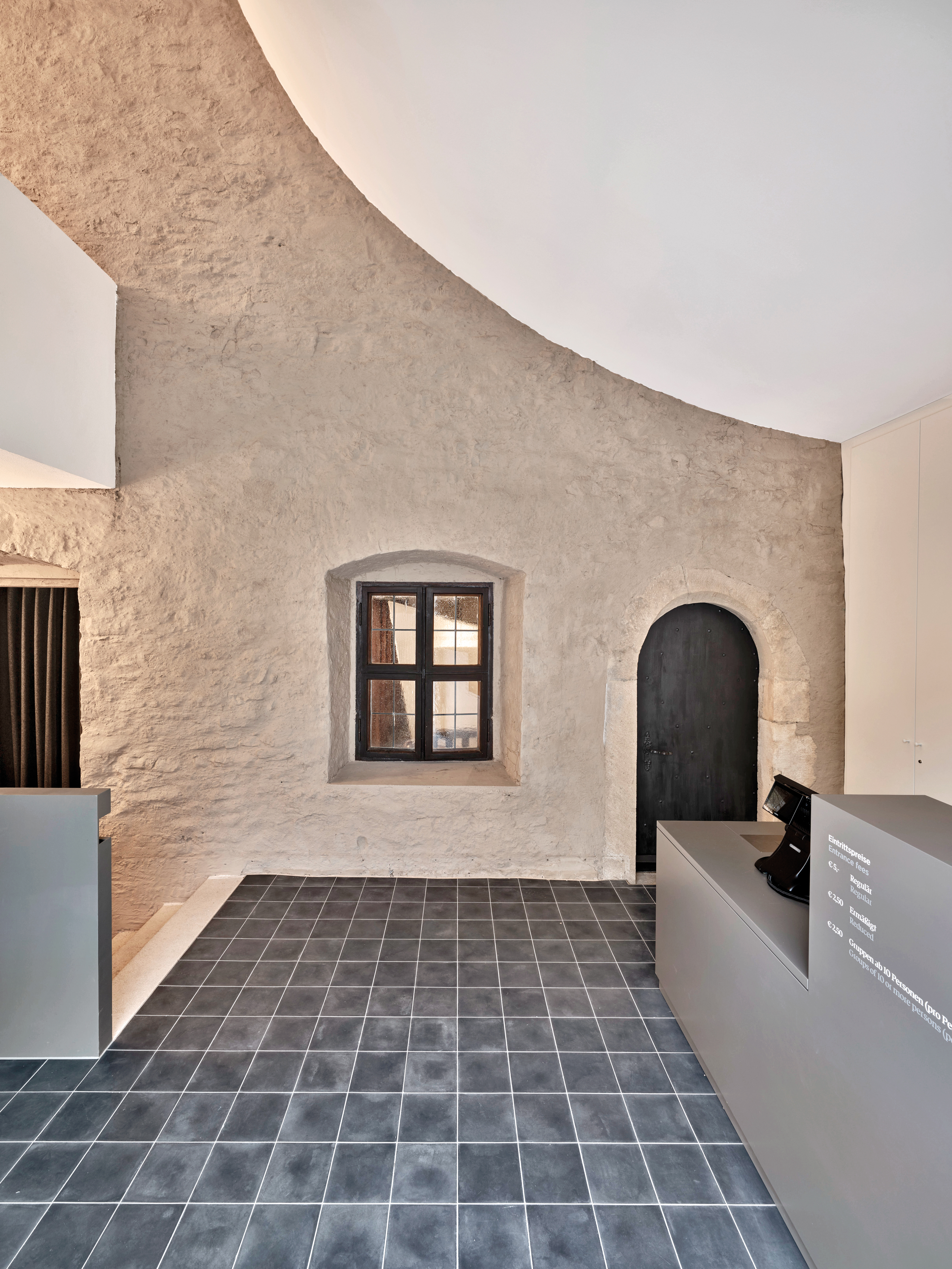What had been the old exterior wall has now become a new interior wall. This is revealed by the painted finish and the render that both correspond to the outer facade design.