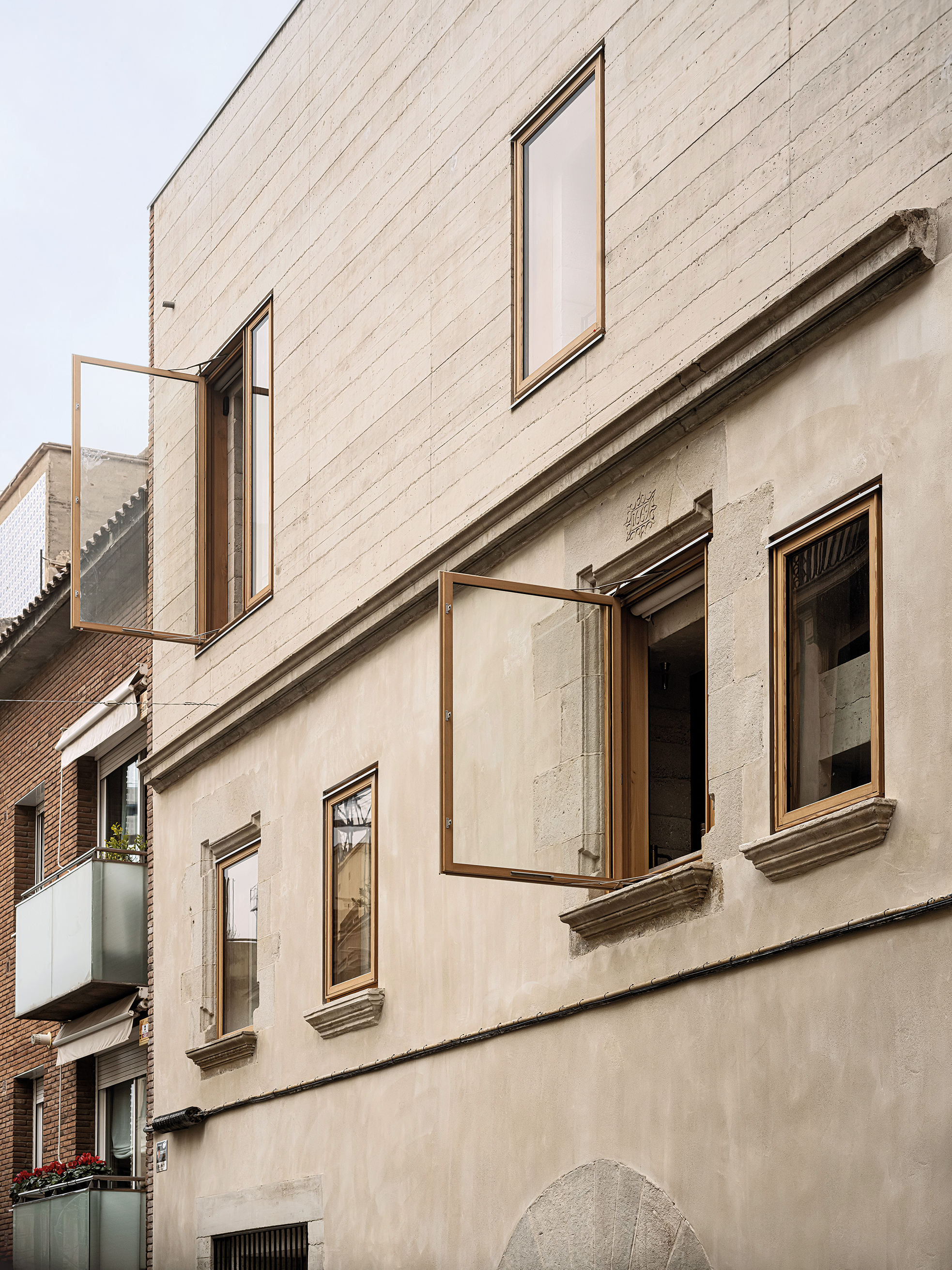 Die Fassade an der Straßenseite blieb erhalten und wurde um ein Geschoss aufgestockt. Hier gibt das Material erste Hinweise auf das Innere.