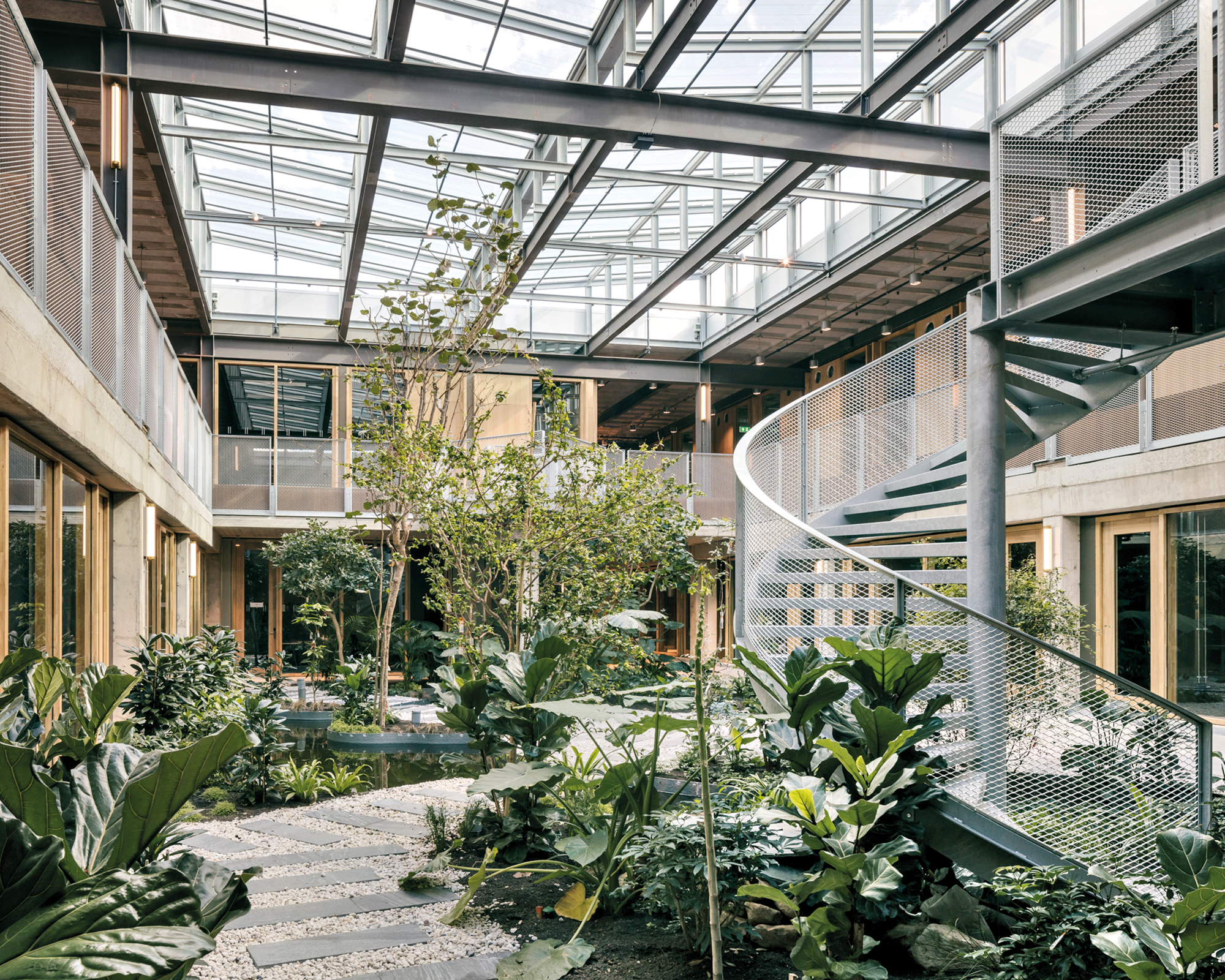 The glass roof with its V-shaped cross section collects rainwater that is used to irrigate the tropical plants in the atrium.