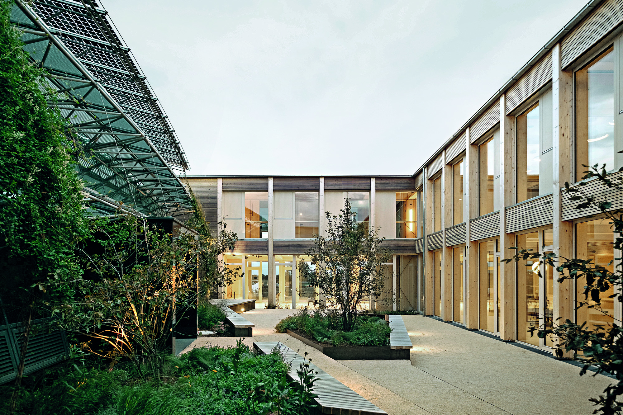 Courtyard encounter: to the left the former headquarters of Windkraft Simonsfeld, built by Georg W. Reinberg in 2014, to the right the 2025 expansion by Jury Troy Architects.