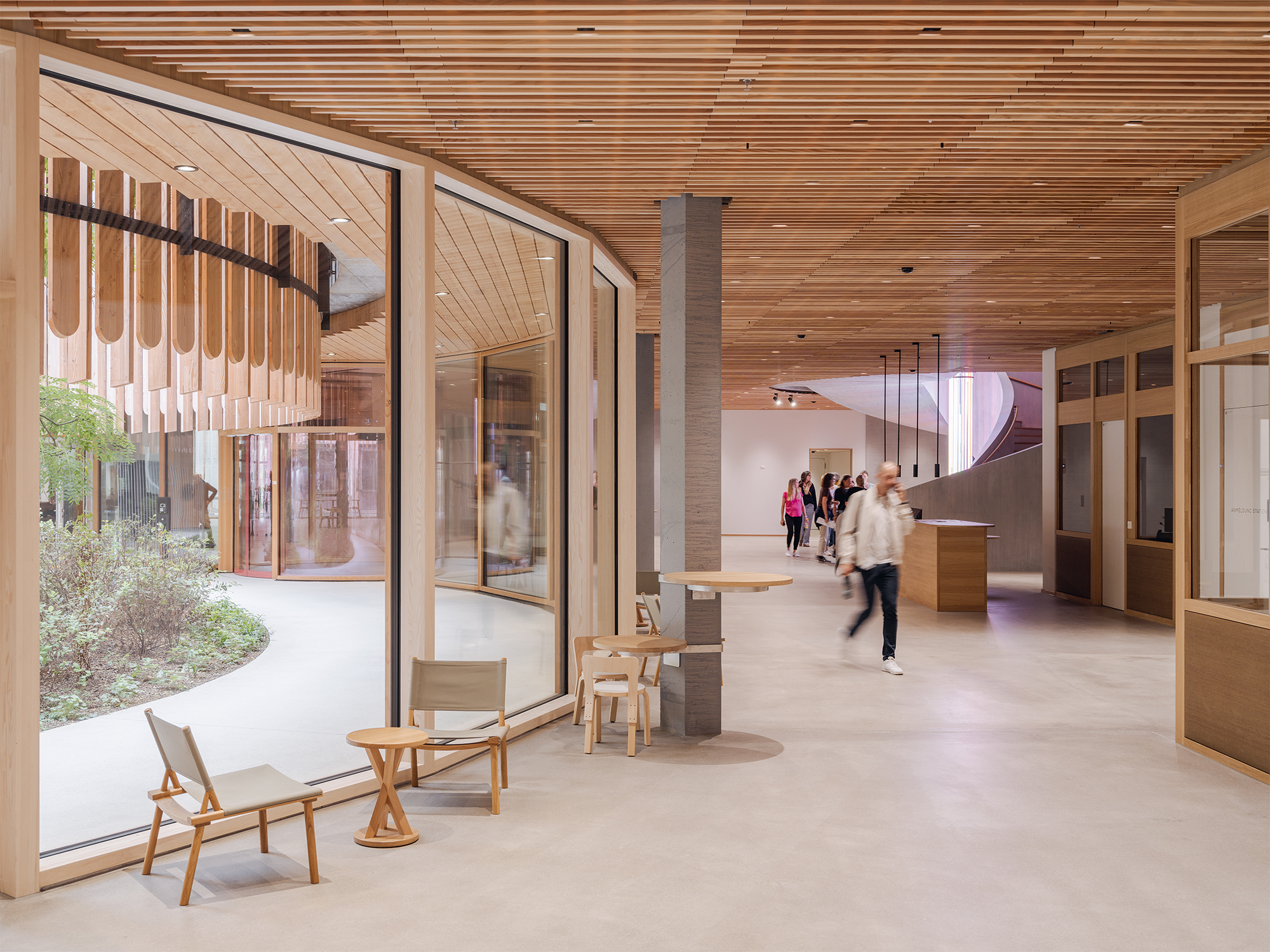 With plenty of wood in the interiors, natural colours, and greened courtyards, Herzog & de Meuron establish a warm and comforting environment.