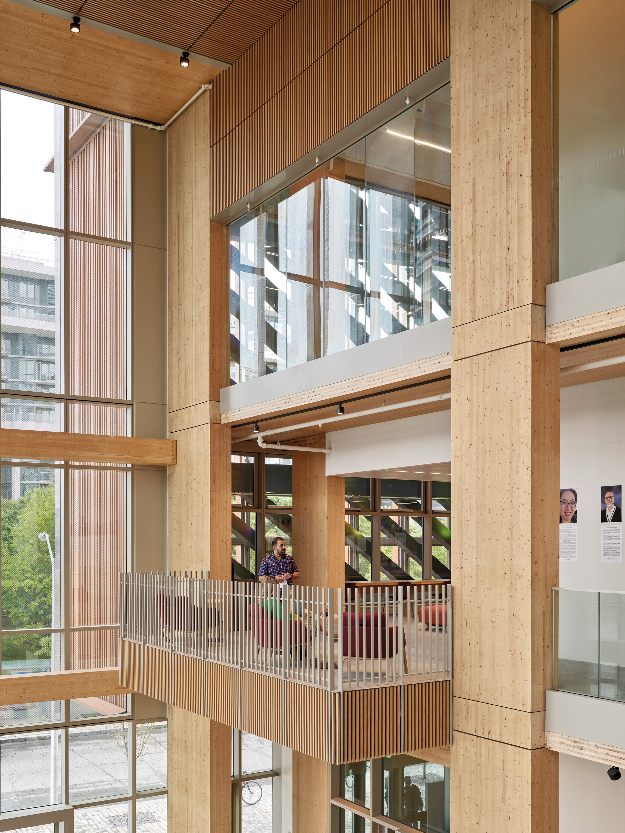 In the entrance hall, the edges of the cross laminated timber ceiling slabs bordering the gallery levels are visibly exposed.
