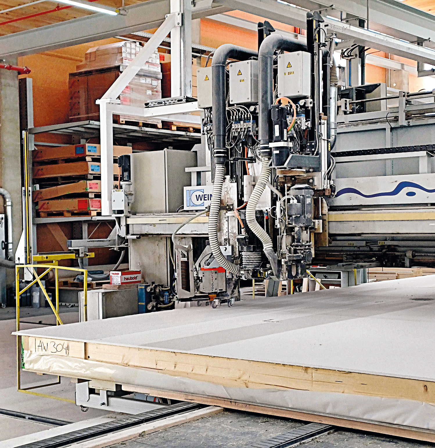 Multifunctional bridge with automatic screwdriving machine for timber element assembly. Screwed connections between timber frame and sheathing are time-consuming but are easier to release than staples.