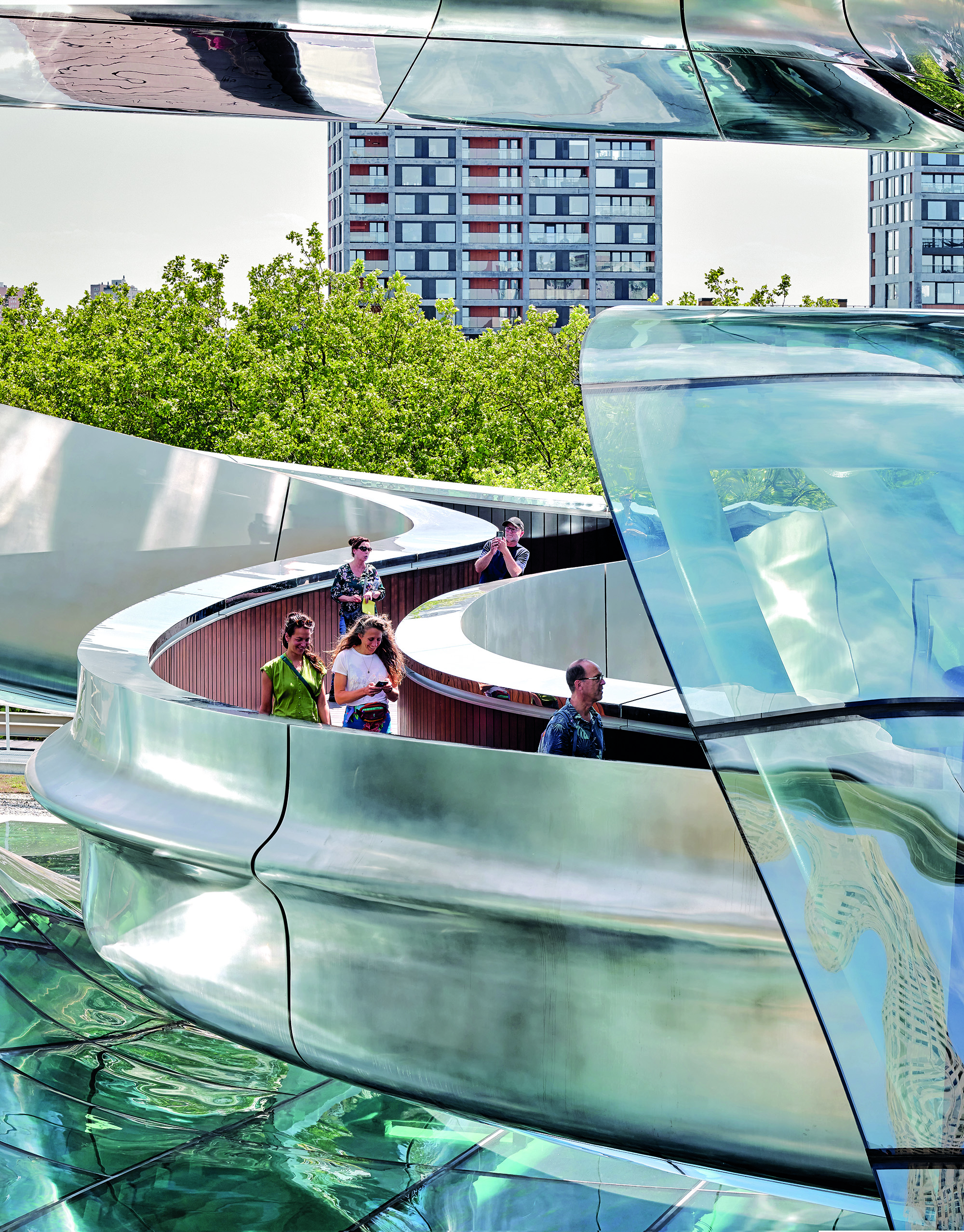 A rollercoaster silhouette as a built metaphor for migration: The ­double-curved staircase sculpture in ­polished stainless steel forms the centrepiece of the Fenix Museum in Rotterdam.
