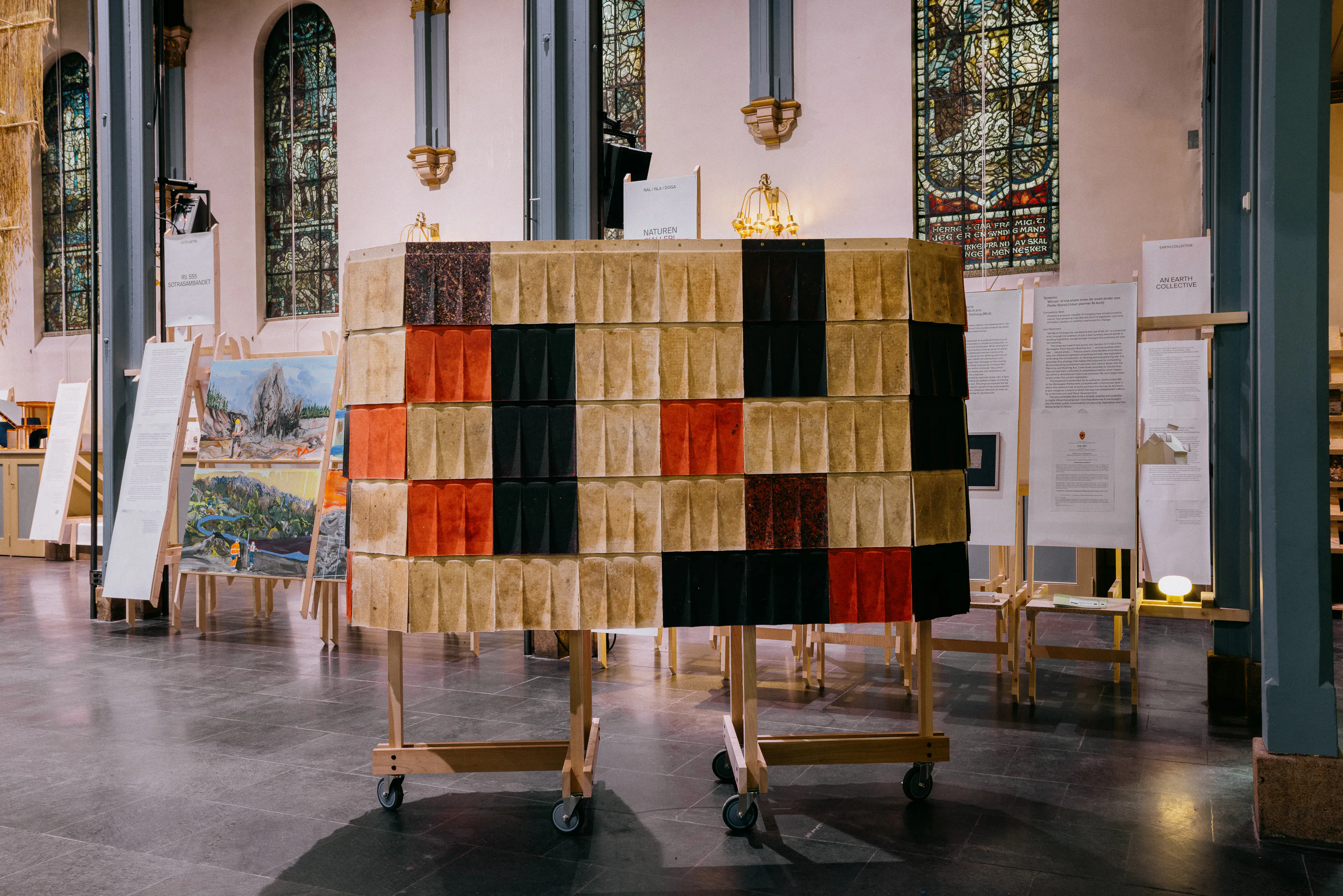 Die äußere Schicht sind kannelierte, mehrfarbige Fliesen, dahinter liegt eine Dämmschicht, die Unterkonstruktion ist aus Holz.